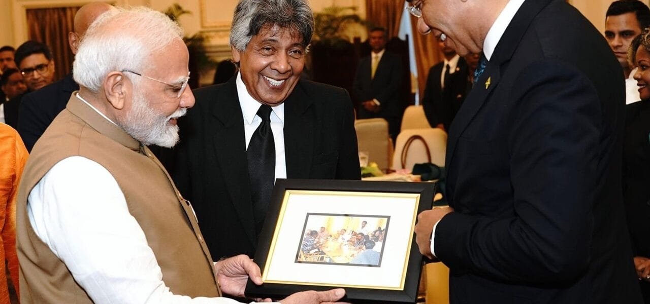 Jamaican Prime Minister Dr. Andrew Holness presents a photograph of Prime Minister Narendra Modi from his visit to Montego Bay, Jamaica in 1999