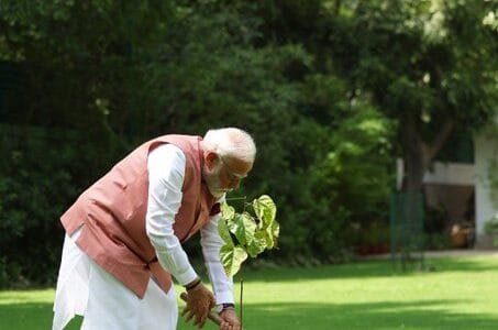 PM Modi plants a vermilion tree at his residence in New Delhi on the occasion of World Environment Day